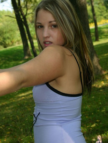 Amateur teen goes for a walk in the park attired in a short dress