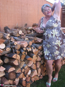 Brazen older granny strips off by the wood pile to show off BBW tits & big ass