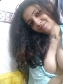 Indian solo girl holds her face firm while letting nipples free of lingerie