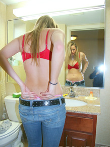 Sexy Cassie peels off her jeans in the bathroom showing hot ass in thong