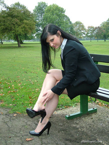 Fully clothed model Nicola takes a walk on park pathway in her new black pumps