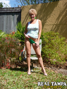 Mature lady takes off hr underwear to show her twat on a chair in backyard