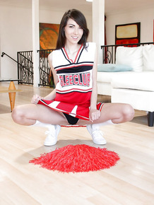 Naughty teen girl Emily Grey posing solo in sexy cheerleader uniform