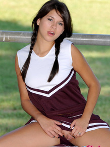 Pretty cheerleader Shyla Jennings casually exposes her snatch and nice tits