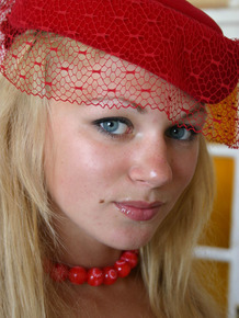 Young blonde girl Valya B wears a fancy hat while modeling in the nude