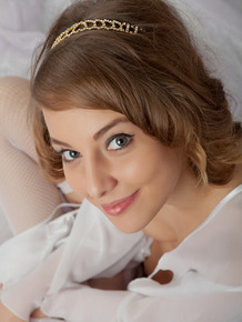 Sweet teen girl has the look of an angel while posing in just white nylons