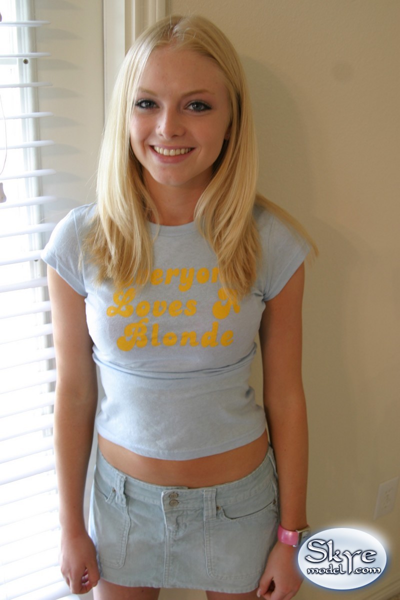 Blonde amateur Skye Model models by herself in a short skirt pic image