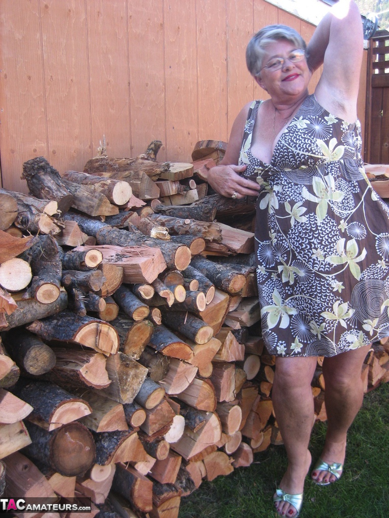 Brazen older granny strips off by the wood pile to show off BBW tits and big