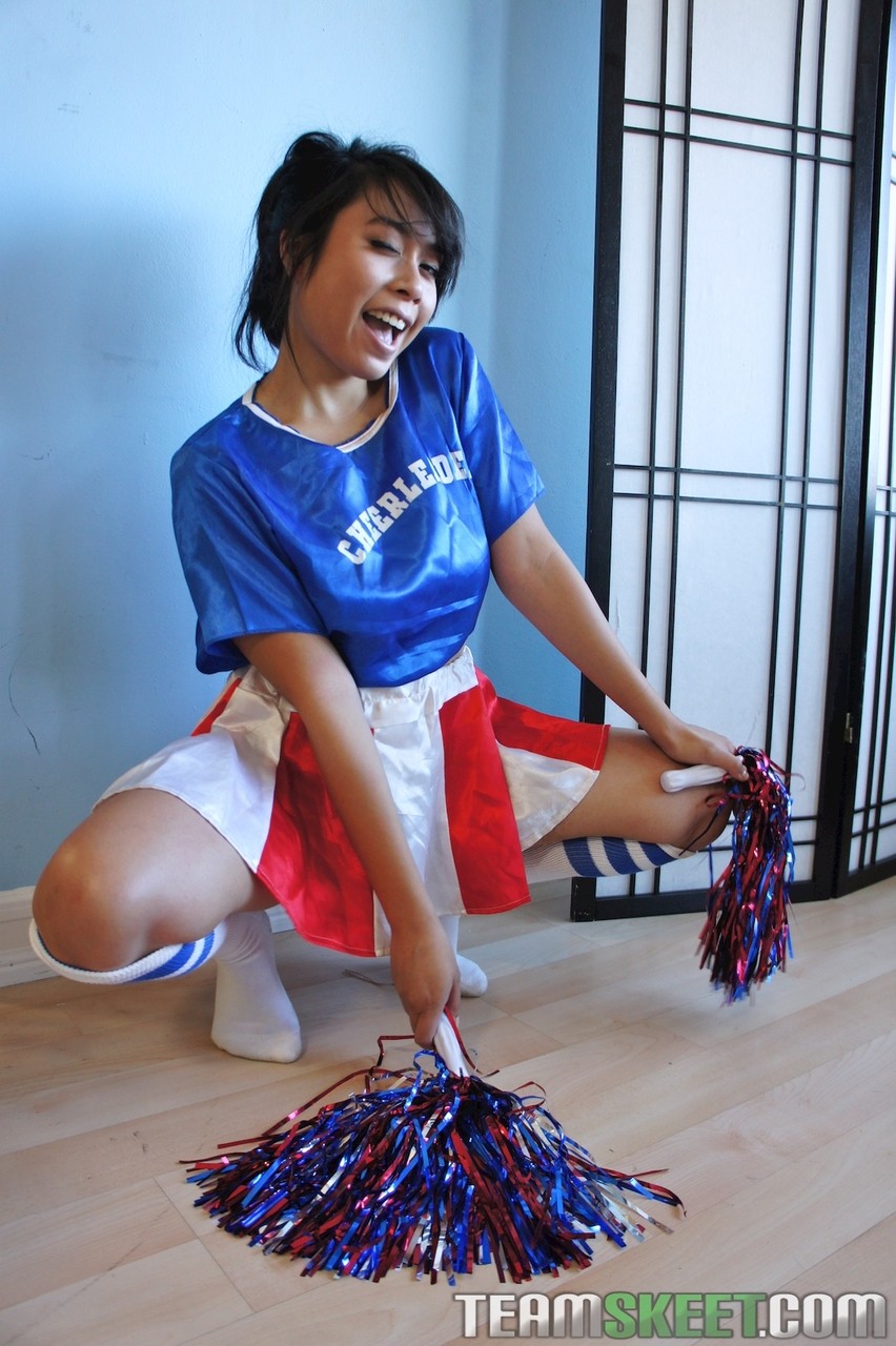 Sweet teen Asian cheerleader May Lee fucks two team members in her uniform  pic