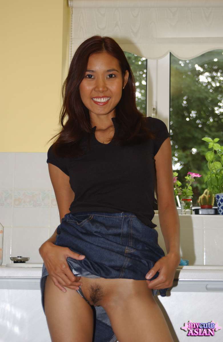 Leggy Asian amateur strips totally naked on her kitchen counter